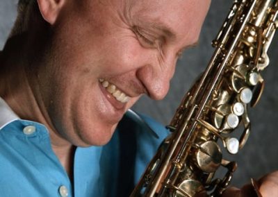 Headshot, closeup informal Scott M. Graves in profile with Tenor Saxophone in hand