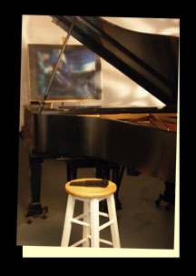 The Jazz Room. Black Steinway Piano, stool and microphone in foreground. Abstract painting in background