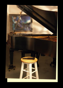 The Jazz Room.  Black Steinway Piano, stool and microphone in foreground.  Abstract painting in background