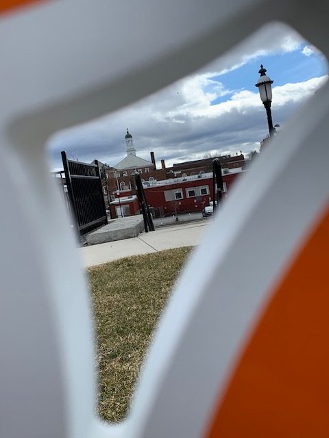 Close-up taken from the Gardner, MA 'Love' sign currently housed in center of the city. White and Orange cut-out signs of each letter in the word love.