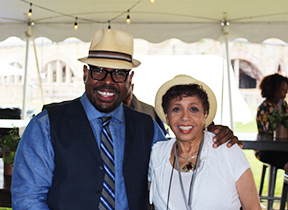 Full color photo of the host of our show, Joan Watson-Jones and Jazz Bassist Christian McBride from the Newport Jazz Festival