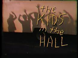 Logo from 1990's Comedy Central Hit, 'Kids in the Hall' silhouetted 'kids' against a flesh colored background, yellow graffiti-like font 'the Kids in the Hall'
