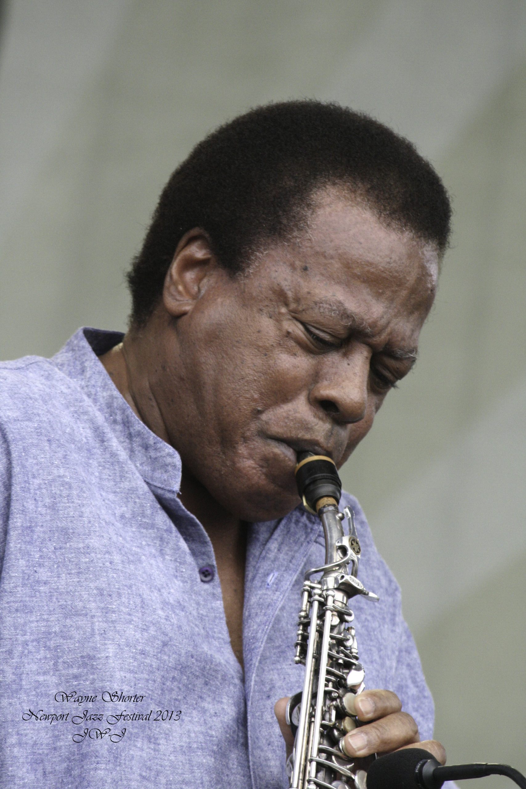 Full color image of Wayne Shorter playing soprano saxophone on stage at Newport Jazz Festival