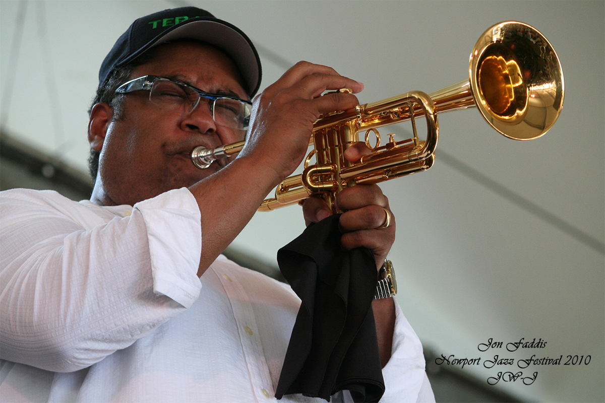 Jon Faddis Signed Full color image against a grey stone wall background of the Royal Boosters with show host Joan Watson-Jones in the center.