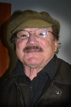 The instrumentalist Frank Tiberi in a buff colored work hat and black shirt