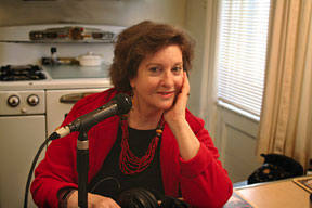 Full color image against a grey stone wall background of the Royal Boosters with show host Joan Watson-Jones in the center. 