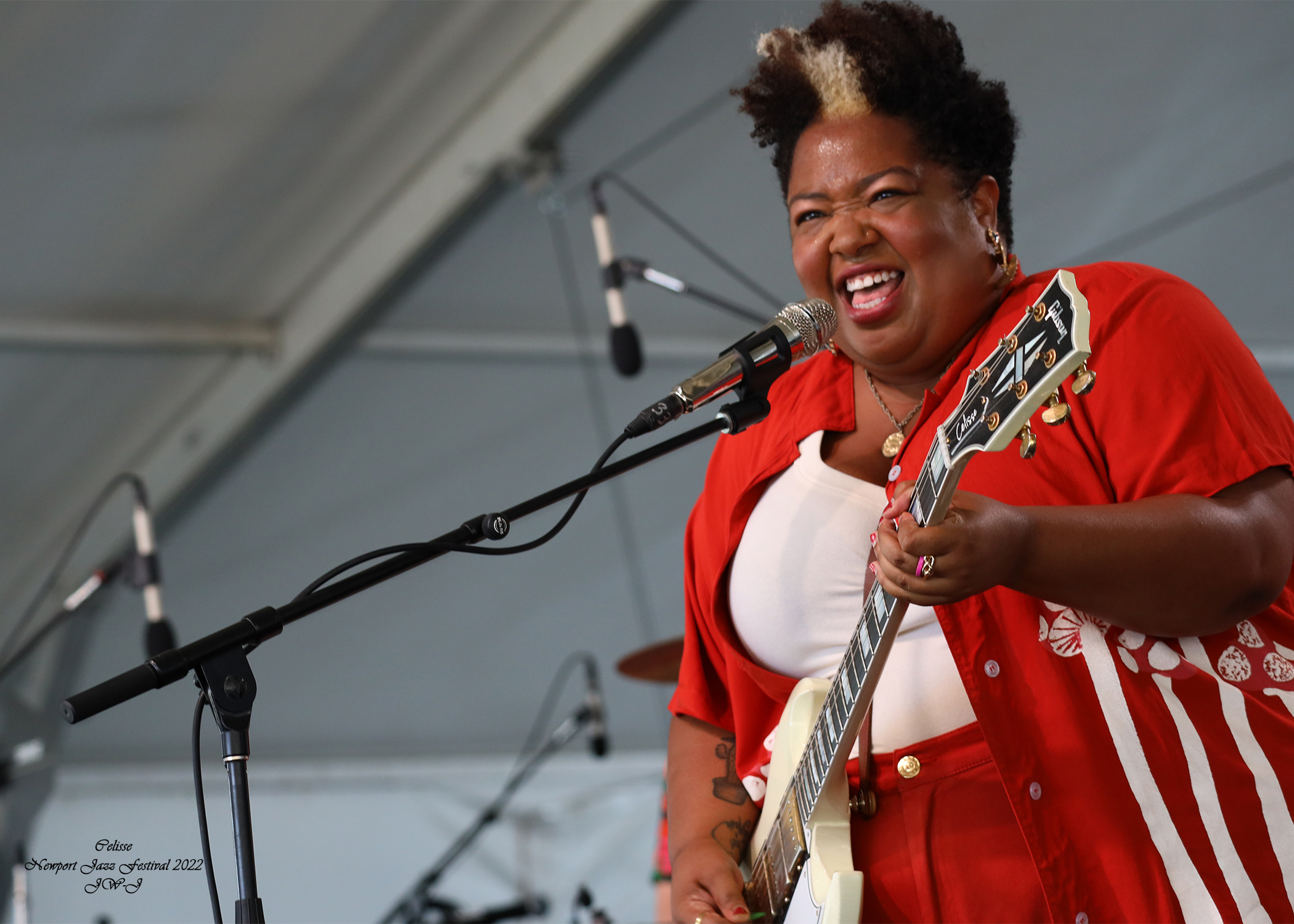 Tony Lynn Carrington behind her drum-set performing at the Newport Jazz Festival, big smile on her face and deeply entranced with the music