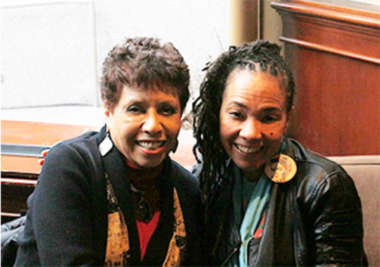 Ful color interior photo of Poet and Spoken Word artist Jessica Care Moore sitting alongside your host, Joan Watson-Jones. 